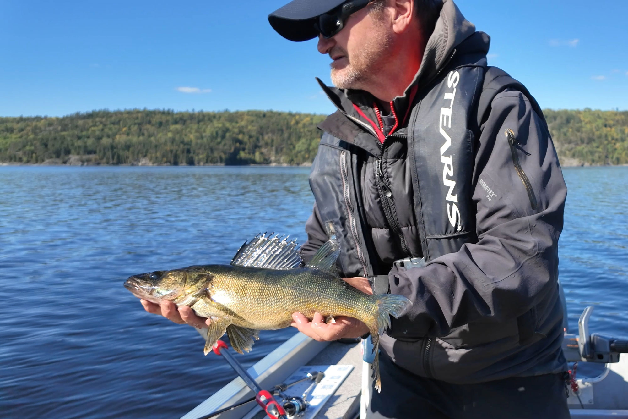 angler fishing walleye from a boat