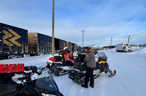 A group of snowmobilers getting ready to ride after exiting the Ontario Northlander train.