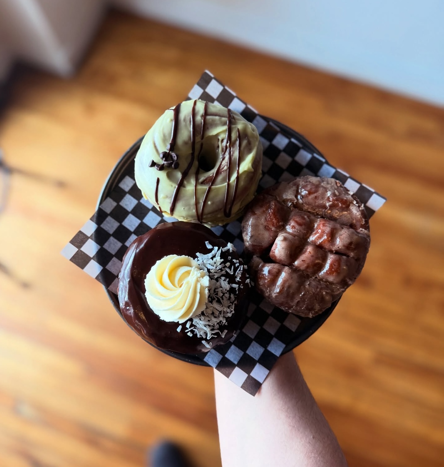 a plate of delicious and decorative donuts held up on a platter at Beards Bakery.