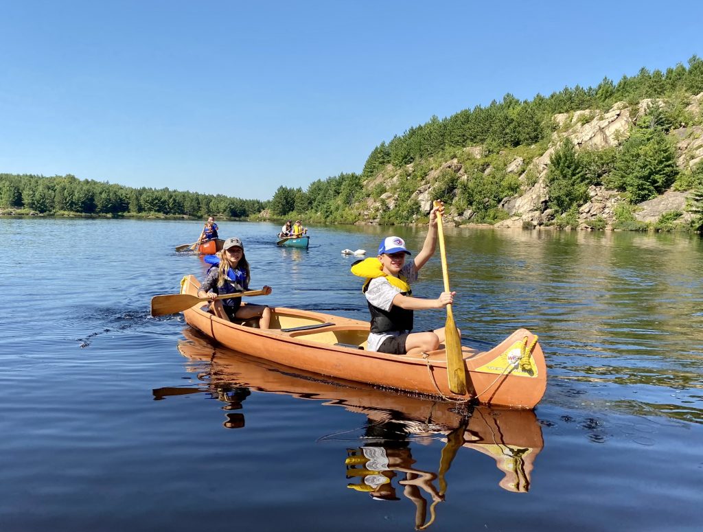 Kids on canoes at Lake Laurentian