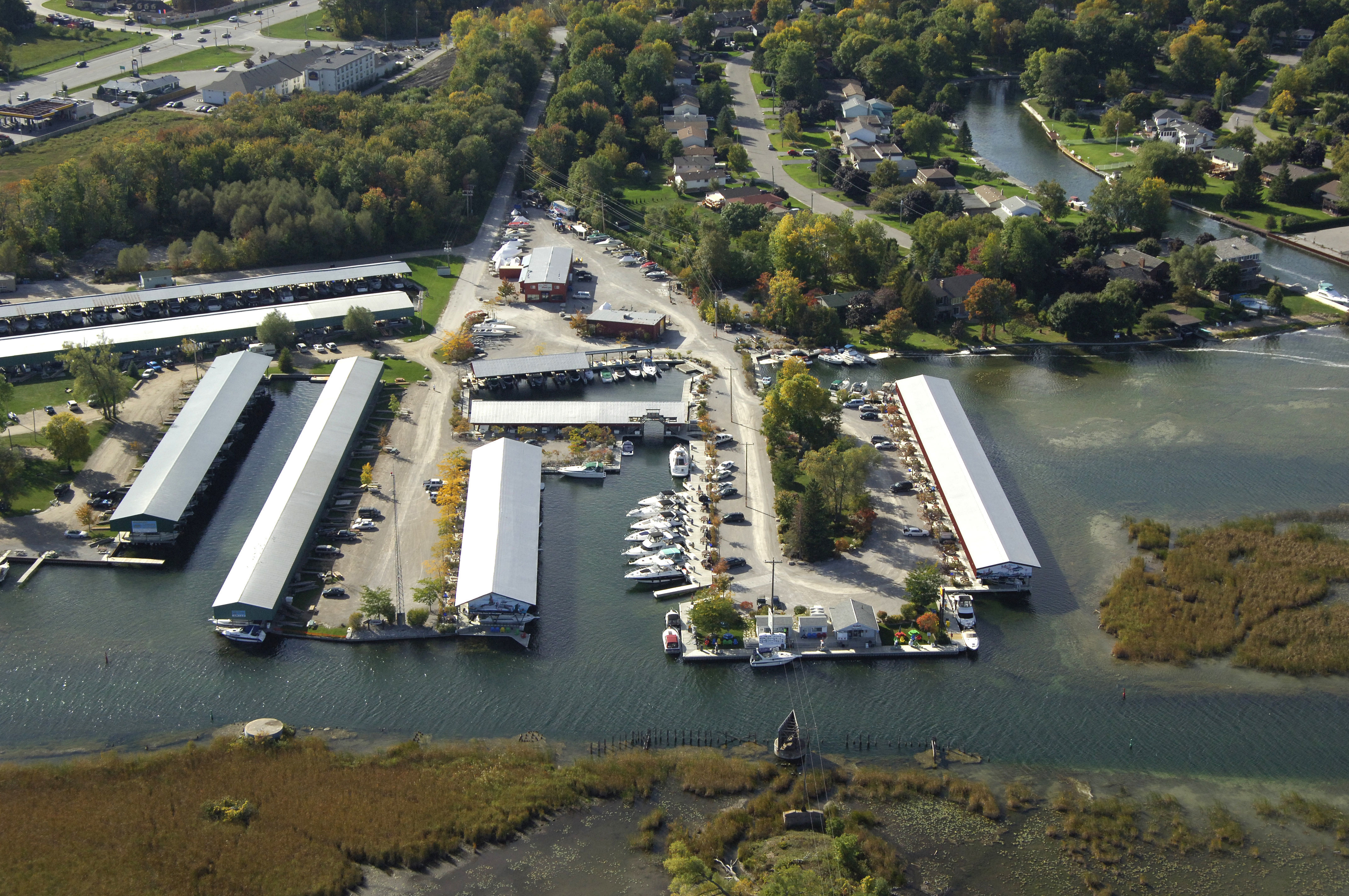 Bridge Port Marina, a full-service marina with over 100 covered and open slips, along a thickly forested shore.