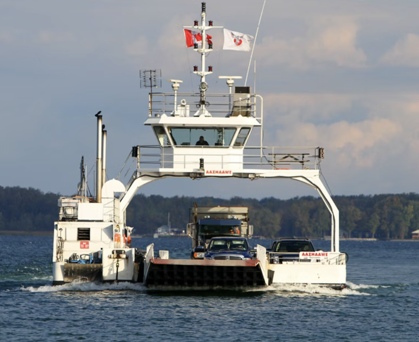 The small Georgina Island Ferry sailing along Lake Simcoe near Virginia Beach Marina. 