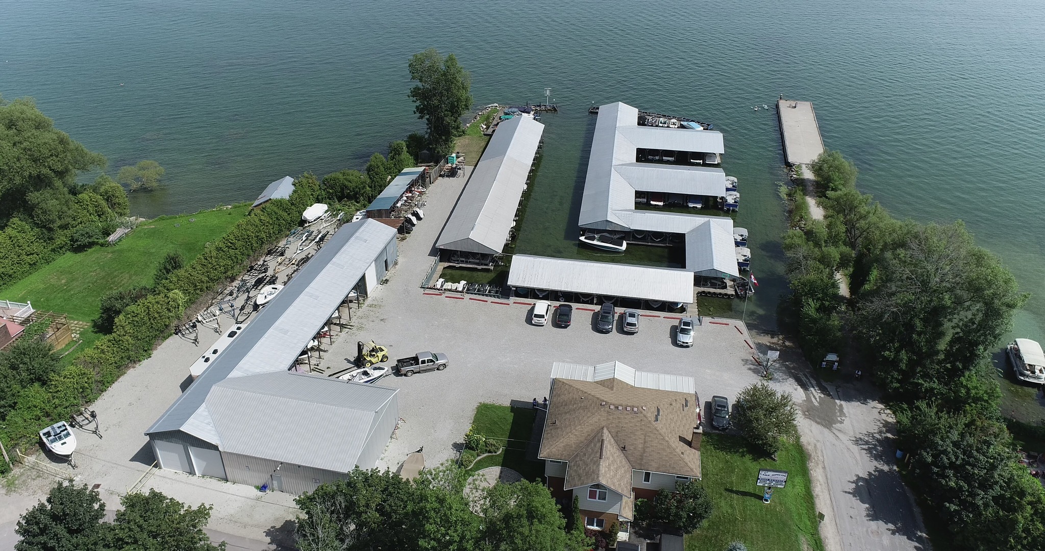 Lake Simcoe Marine, a large well-kept marina with rows of covered slips on the calm blue-green water of Lake Simcoe.