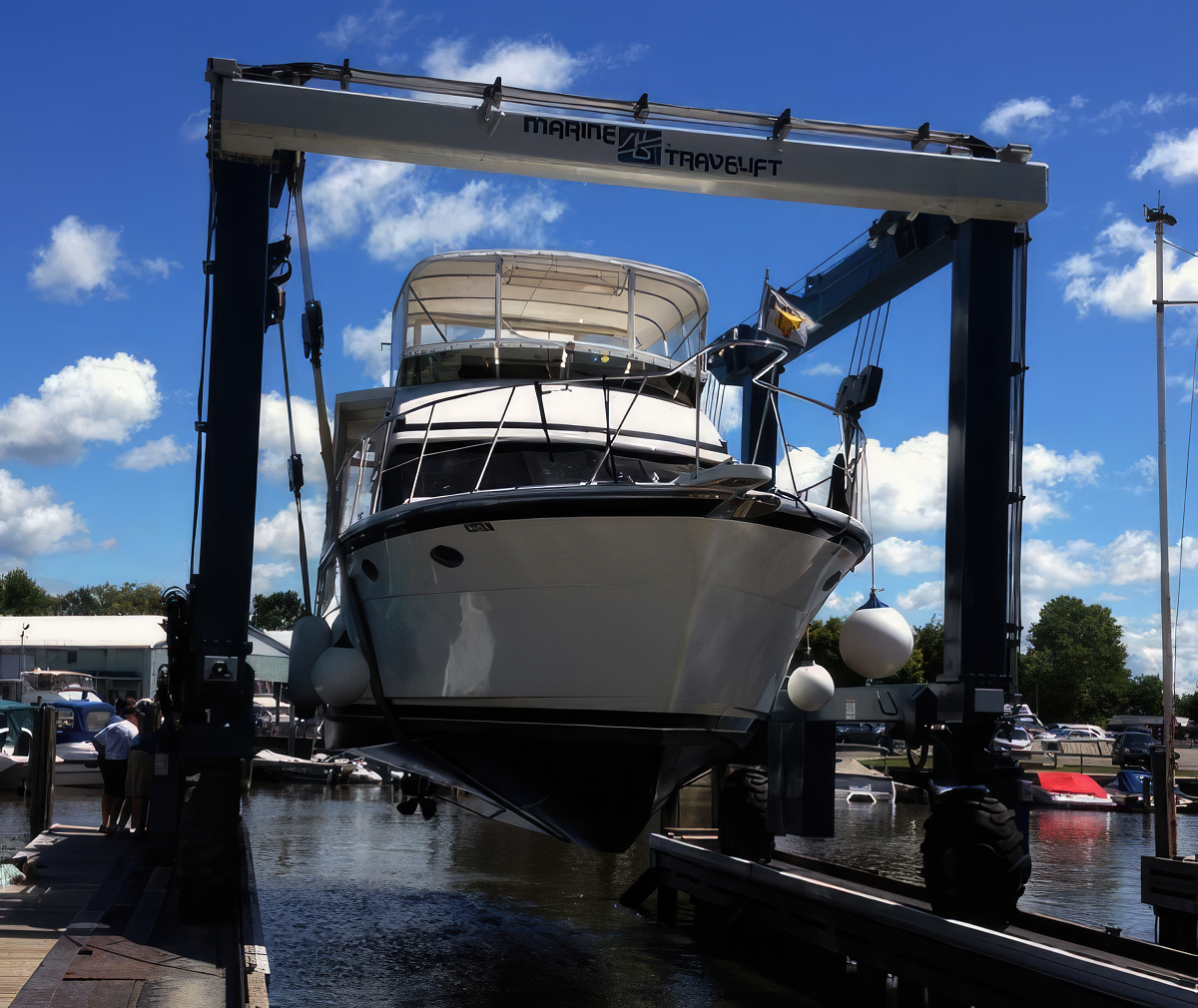 A boat is loaded into the travel lift at Krates Marina.