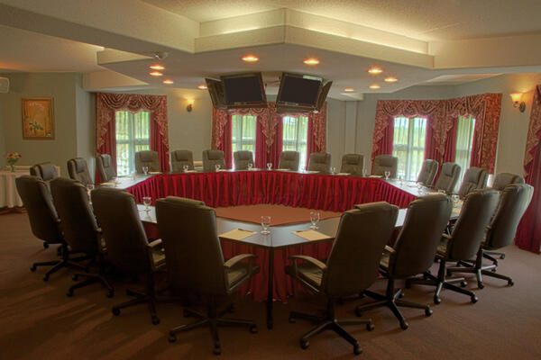 An elegant and warmly lit boardroom at Cedar Meadows in Timmins.
