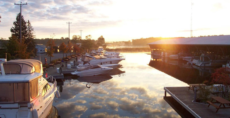 Boats in the slips at Bridge Port Marina at sunset.