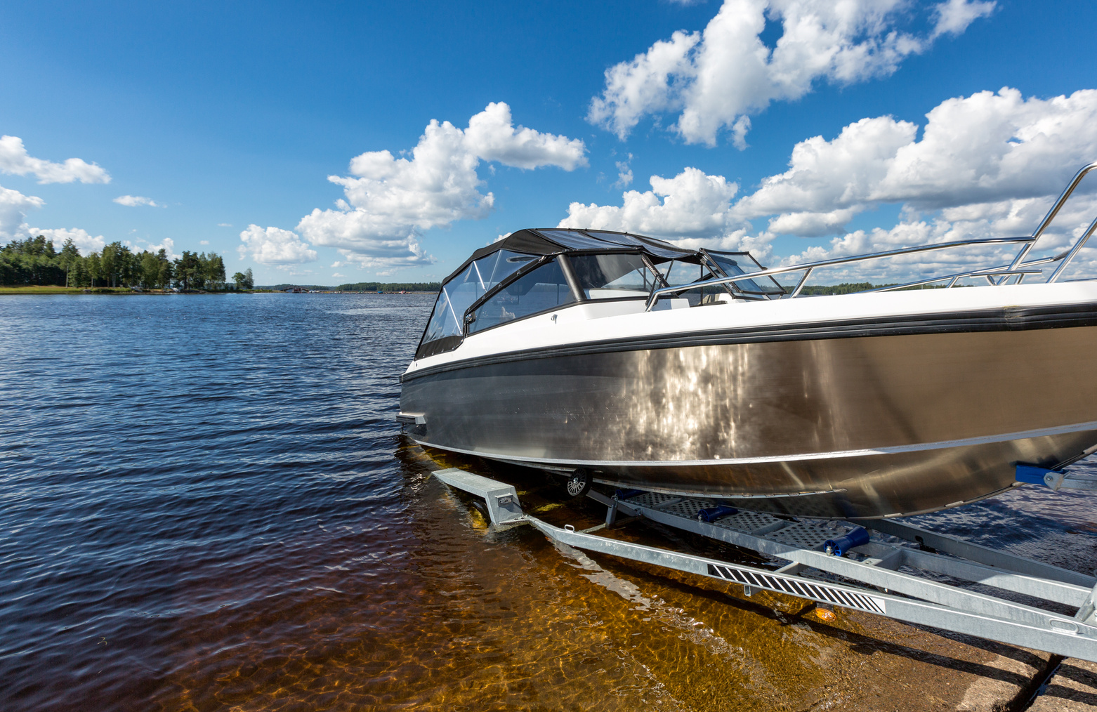 a boat being lowered into the water at a launch. 