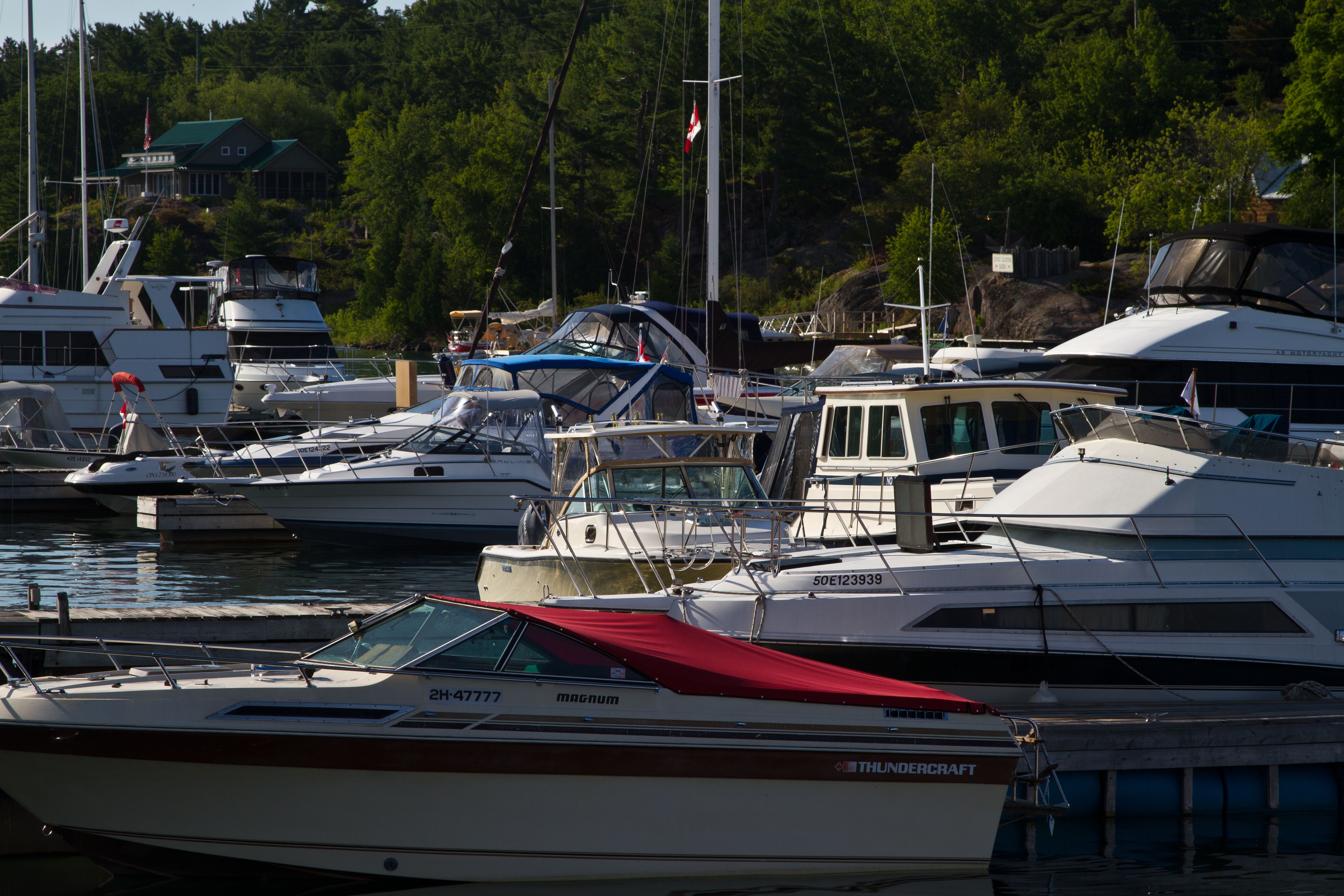 Boats parked in the slips on a sunnh summer day at Killarney Marina.