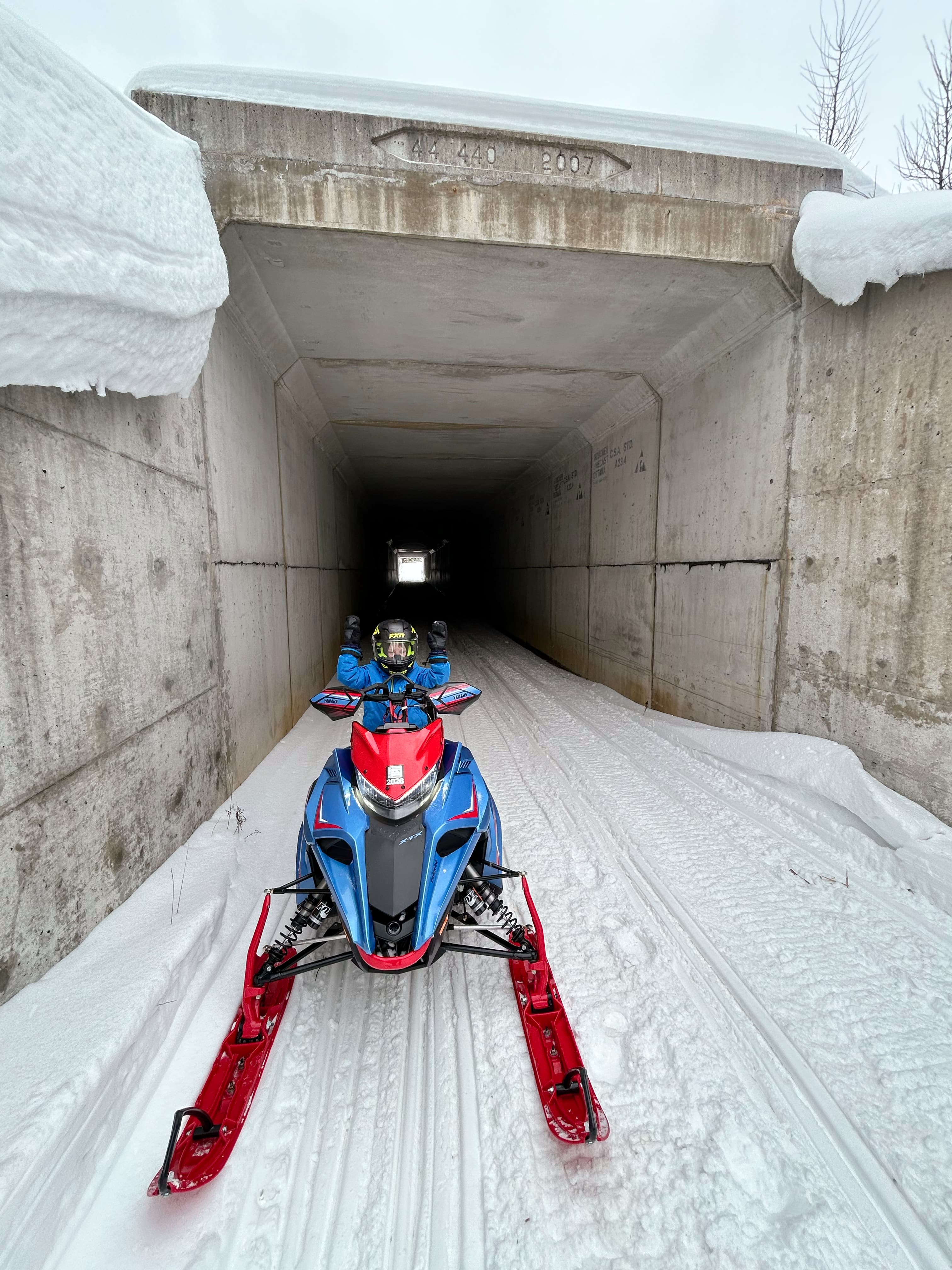 snowmobile emerging from underpass