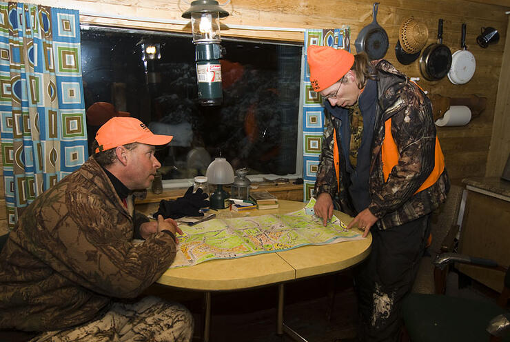Studying the map back at the hunt camp on a late season deer and moose hunt in Northwestern Ontario