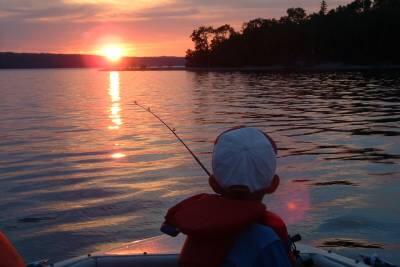 young boy fishing at sunset - rs