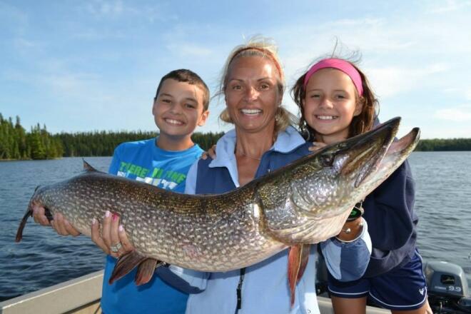 The Malek Family proudly holds their northern pike