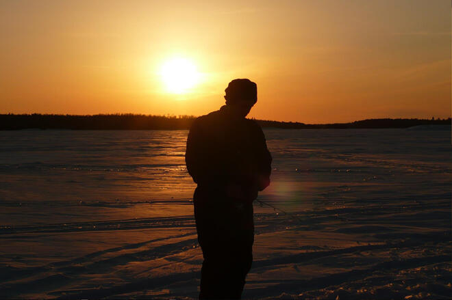 An ice fisherman at Harris Hill Resort on a frozen Lake of the Woods