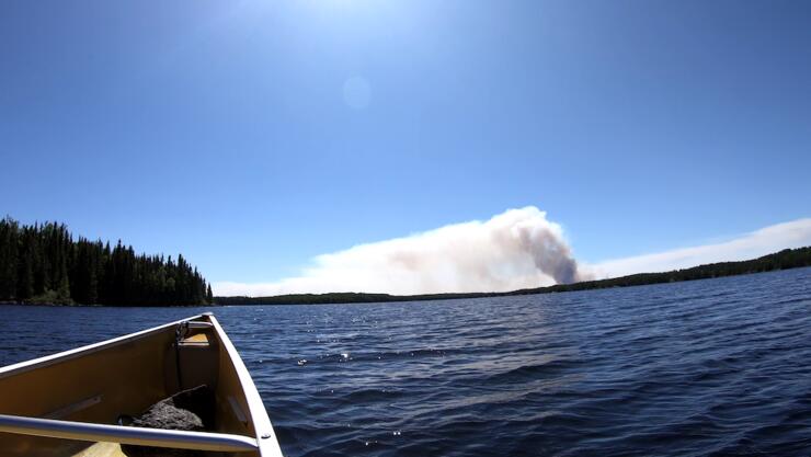 View of bow of canoe on lake.