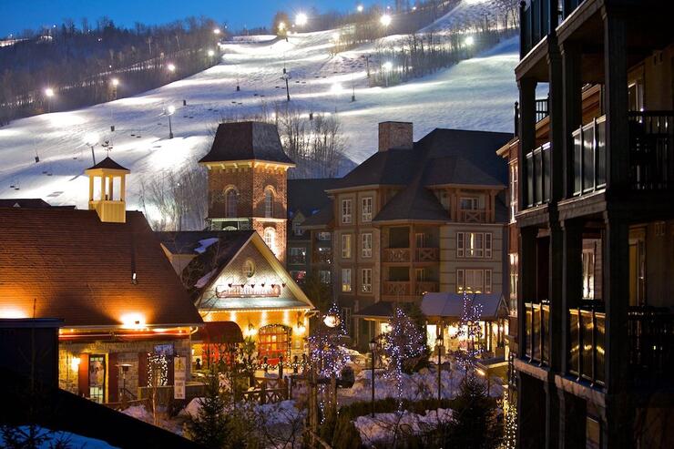 Charming Blue Mountain Resort buildings at night with ski hill. 