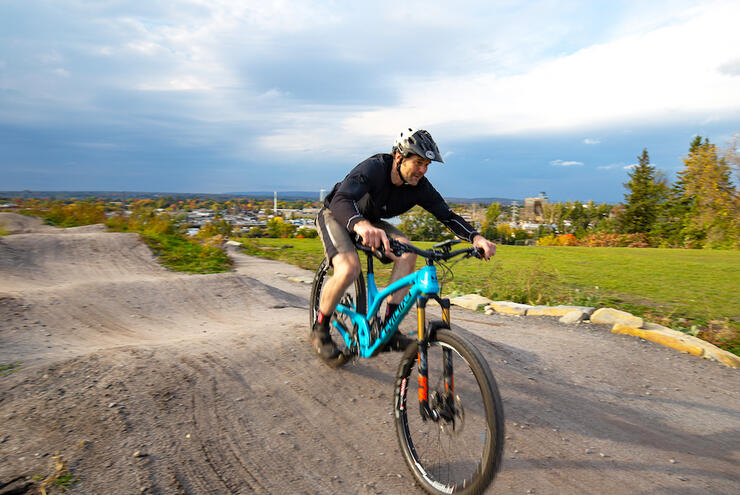 Man riding a bicycle on a pump track. 