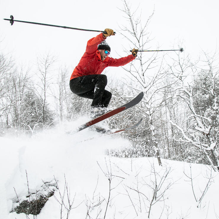 Man on skiis catching some air. 