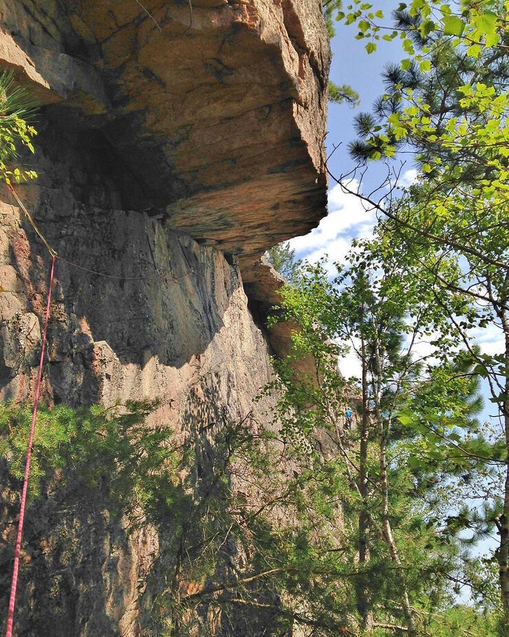 Looking up at a tall rock face. 