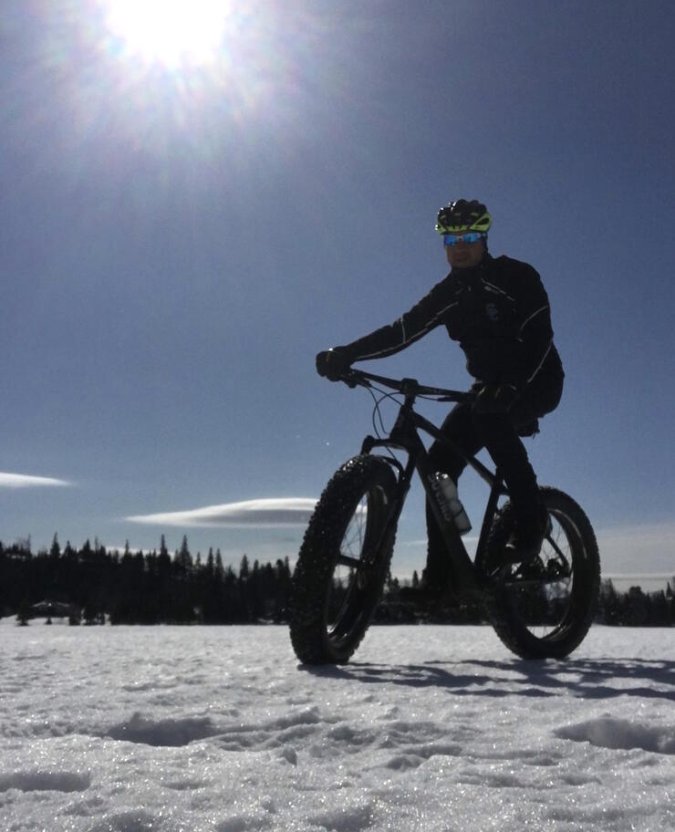 Man on a fat bike riding on the snow.