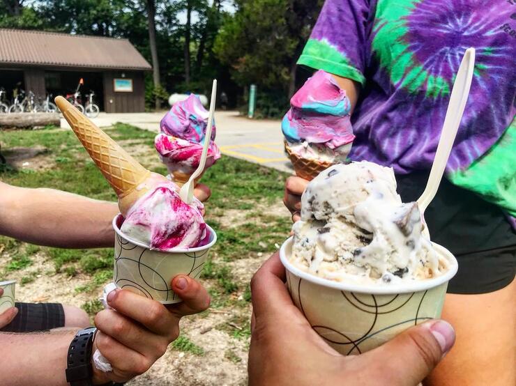 Four people holding ice cream treats. 