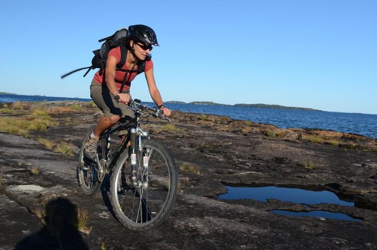 Woman on bike in rocky landscape