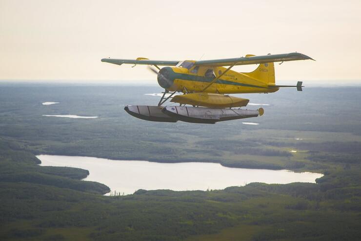 Floatplane flying over lakes