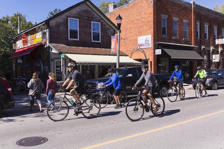 Group of cyclists riding on a town street. 