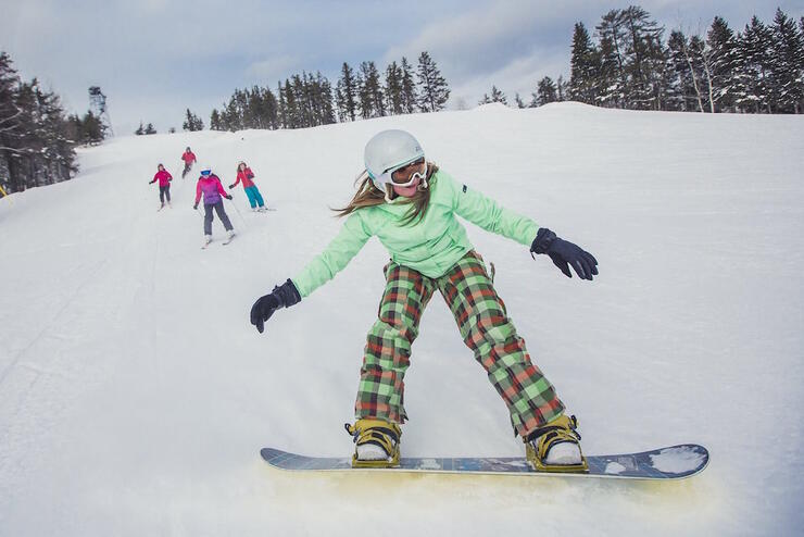 Young girl on snowboard.