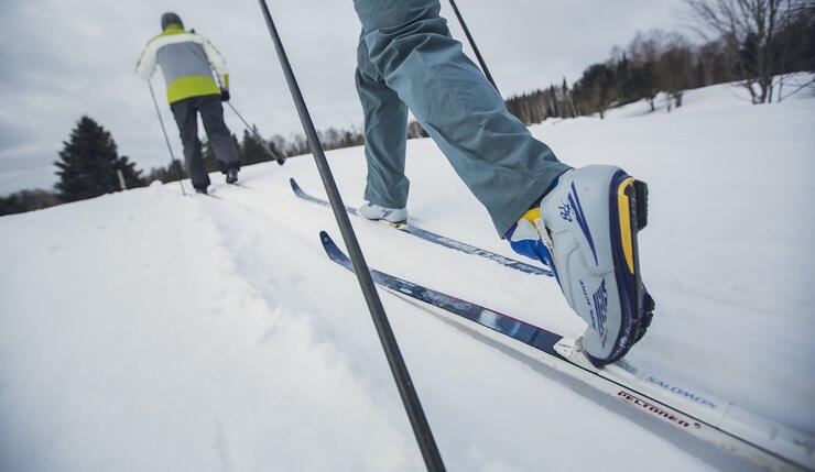 Man cross country skiing on lake