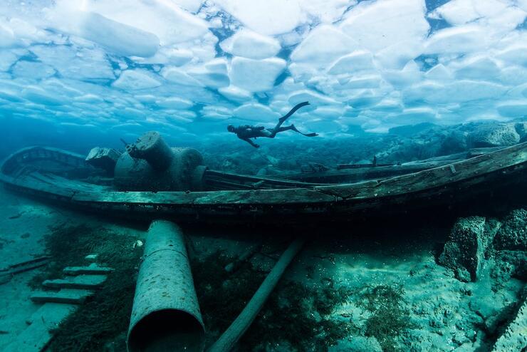 Underwater view of shipwreck with scuba diver
