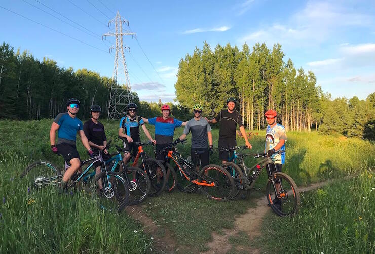 Group of friends sitting on mountain bikes posing for a picture