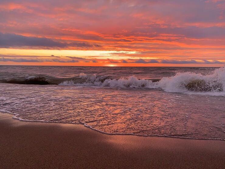 Beautiful sunset over rolling waves. 