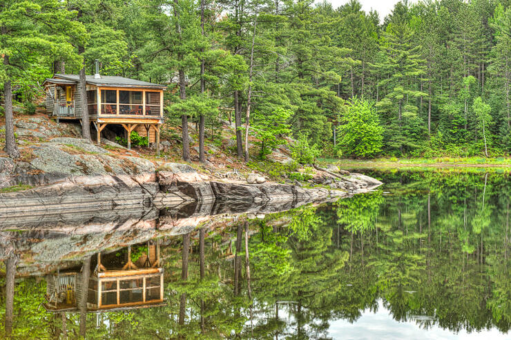 Beautiful cabin perched on shoreline of French River. 