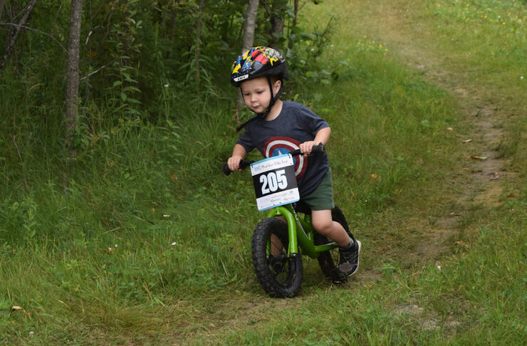 Very young boy on a mountain bike. 