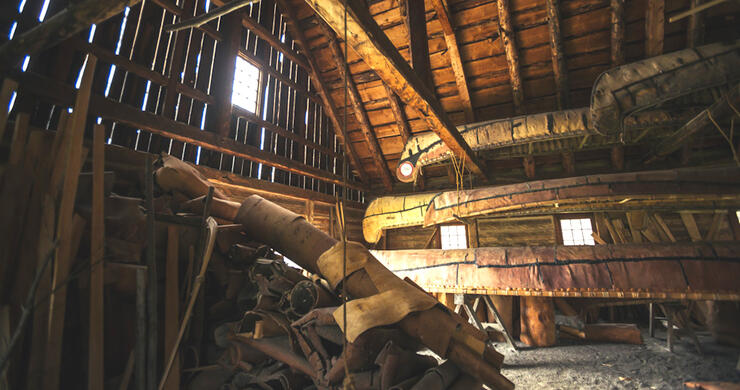 birchbark voyageur canoe hanging in wooden storage building 