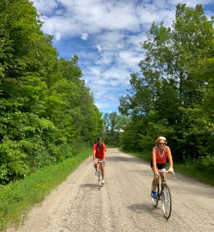 Two cyclists on a gravel country road 