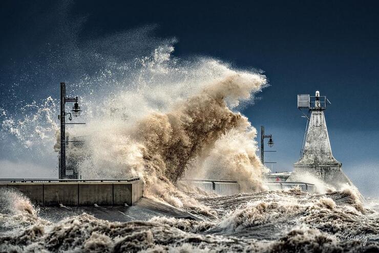 Huge wave breaking on a pier. 