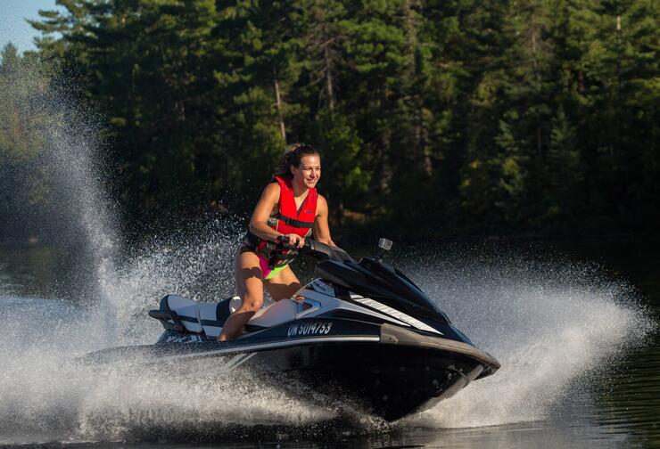 Miesha Tate riding a Yamaha Waverunner in Turtle Lake, Ontario