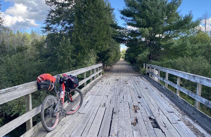 Bicycle parked on wooden bridge on a rail trail 