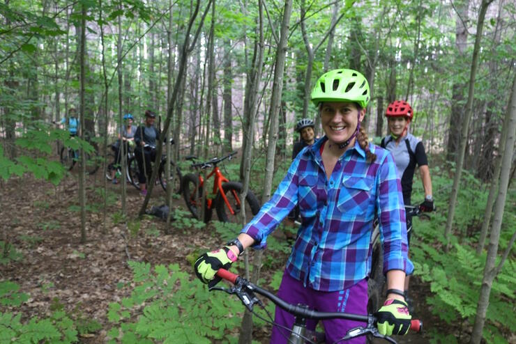 Group of women mountain biking in forest