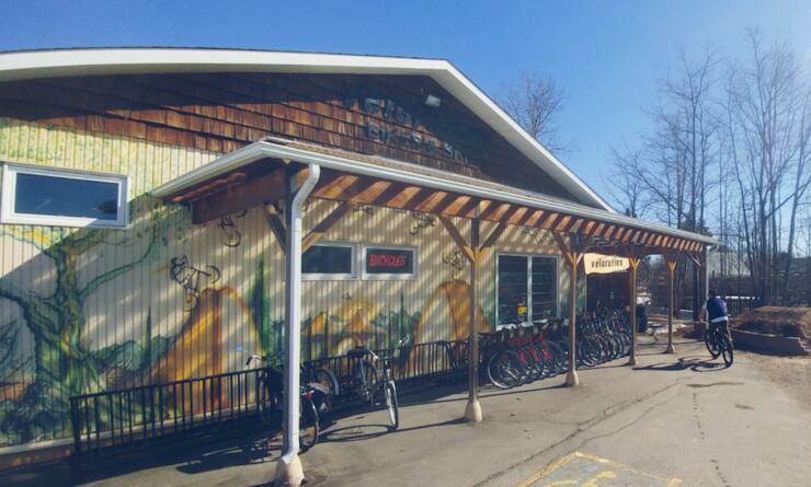 Front of a building with bike racks and art work painted on walls