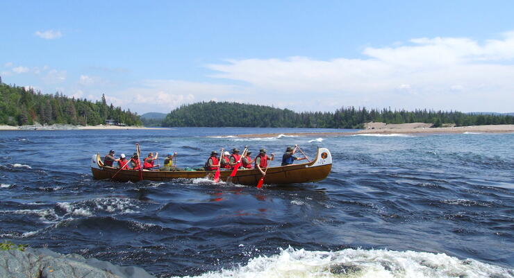 People paddling a voyageur canoe on Lake Superior. 