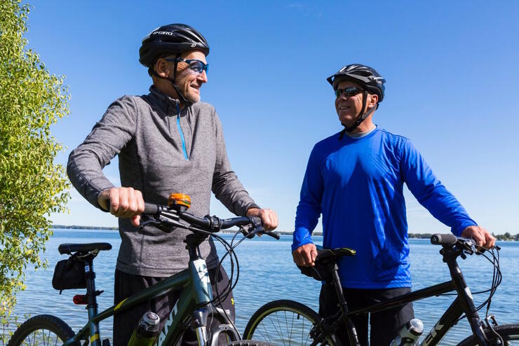 Two cyclists on bike path by water