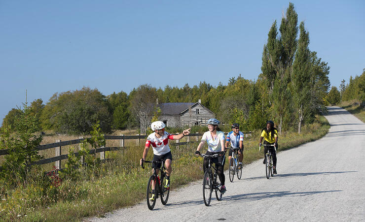 Group of cyclists travelling on a gravel country road 