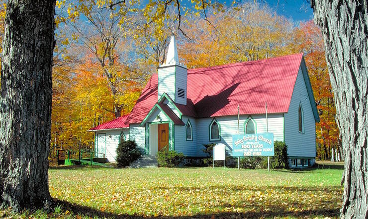 Historical church with red roof and white siding.
