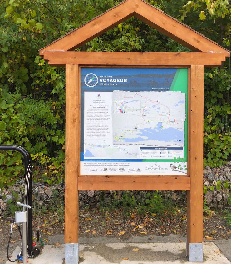 Information kiosk with map of Voyageur Cycle Route and bicycle air pump