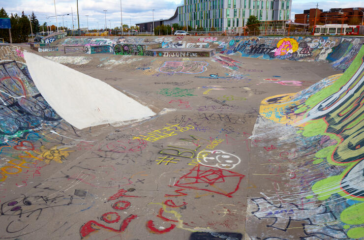 Outdoor bike park covered in colourful graffiti 