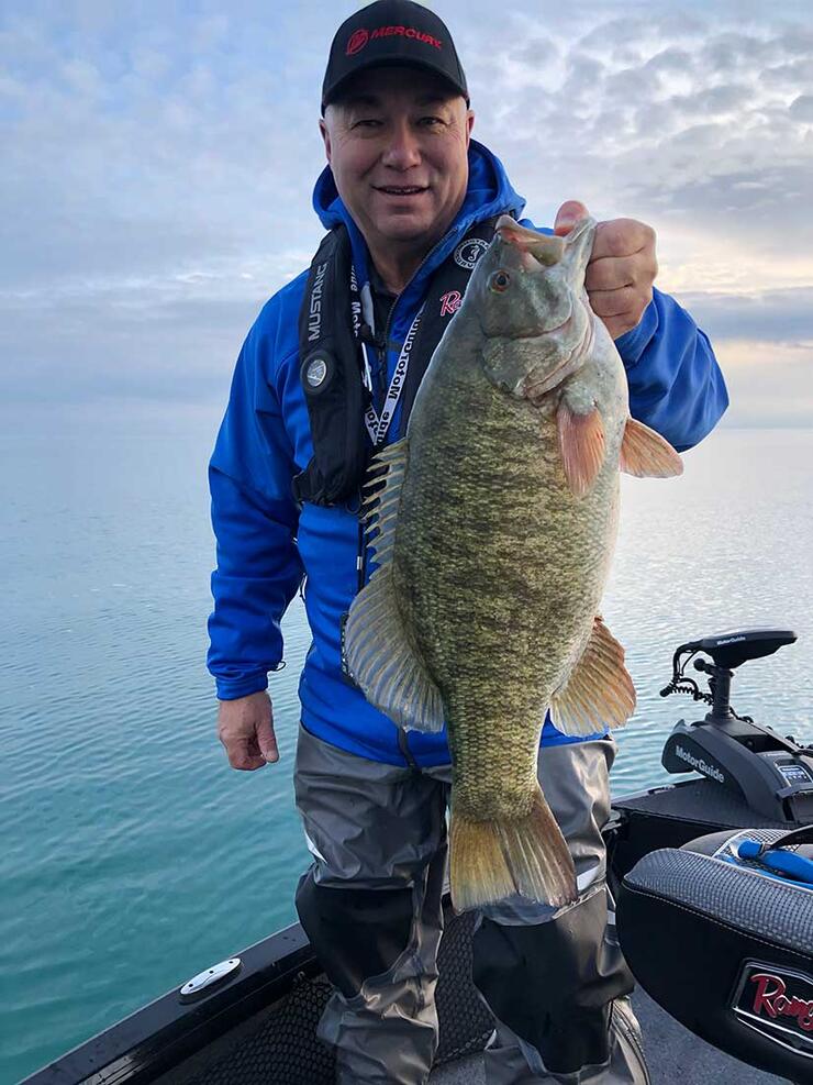 angler holding bass