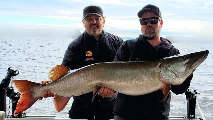 anglers holding fish