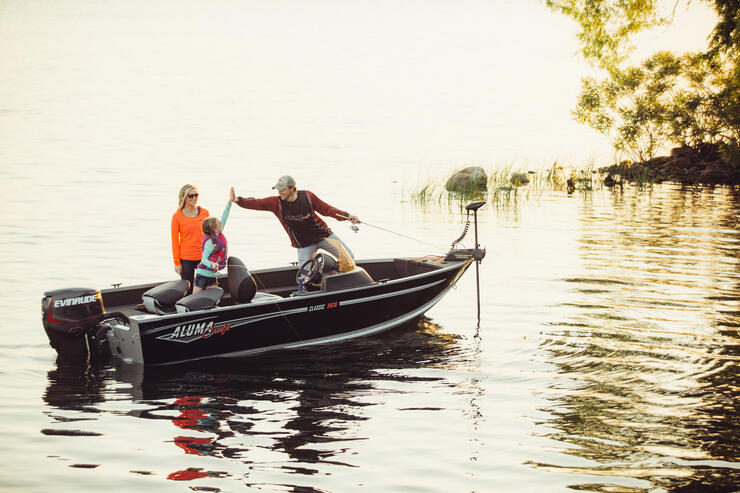 family fishing in boat